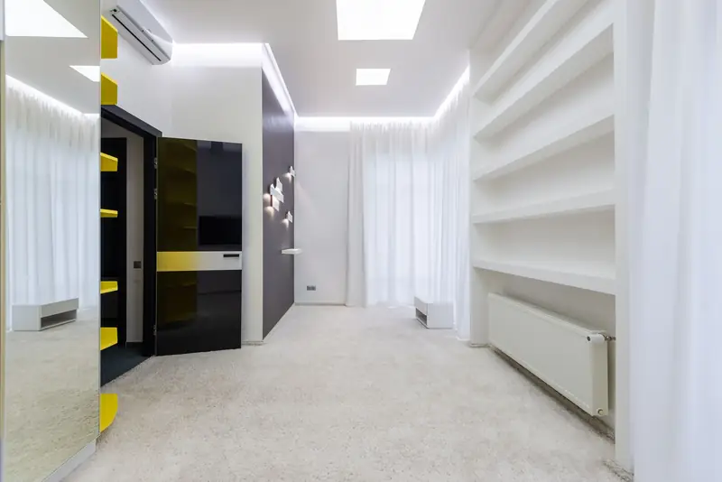 Bright room with smooth ceilings and painted walls