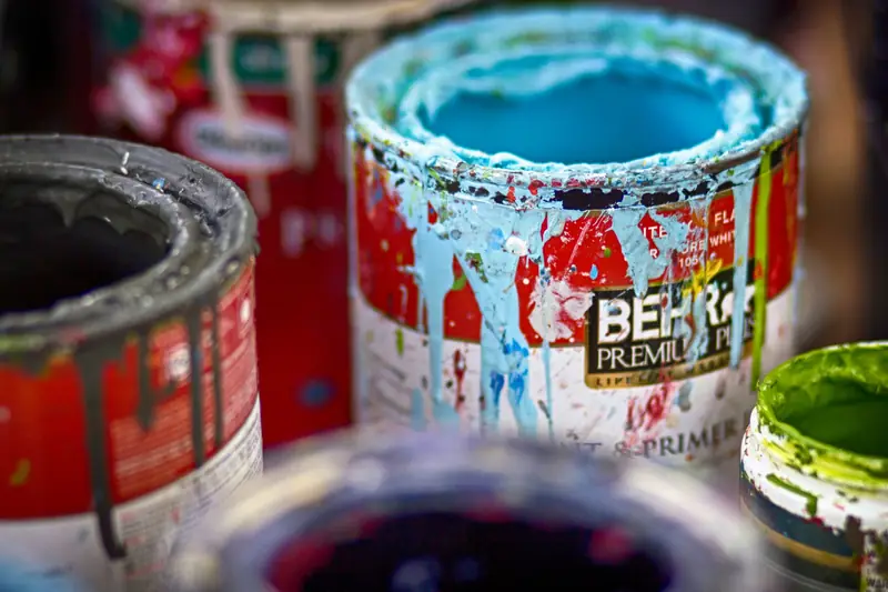 Open cans of paint in different colours